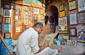 An artist is demonstrating his art by creating pictures decorated with decorative carvings with his artistic skills Near Wazir Khan Mosque in the Provincial Capital.