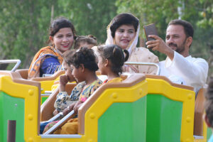 Families with children enjoying the mechanical swing ride at fun land park on the 3rd day of Eidul Azha festival