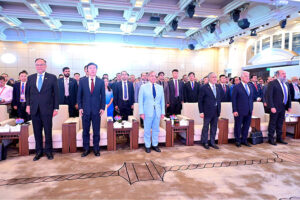 Prime Minister Muhammad Shehbaz Sharif and other guests standing in respect while national anthems are played during Pakistan-China Business Conference.