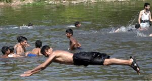 Children splashing and swimming in Korang Stream near Chak Shahzad, seeking relief from the extreme heat wave hit the federal capital as the temperature soared 42°C in federal capital