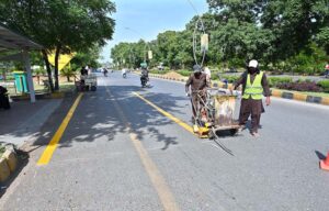 CDA painting crew draw lines for Electric Buses stop in Federal Capital.