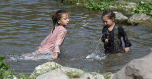 Children splashing and swimming in Korang Stream near Chak Shahzad, seeking relief from the extreme heat wave hit the federal capital as the temperature soared 42°C in federal capital