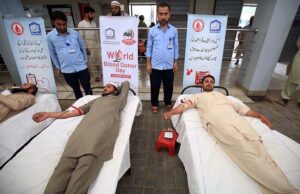 Volunteers donating blood at a camp arranged by Al Khidmat Foundation in connection with world blood donor day.