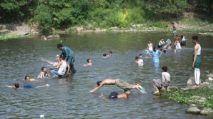 Children splashing and swimming in Korang Stream near Chak Shahzad, seeking relief from the extreme heat wave hit the federal capital as the temperature soared 42°C in federal capital