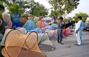 A vendor displaying mosquito net to attract customers at a roadside