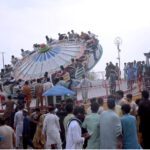 People enjoying ride of mechanical swing while celebrating the 2nd day of Eidul Azha in Fun Land at Clifton beach
