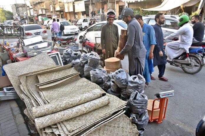 A blacksmith is sharpening knives and axes at his workplace to sell them to the butchers for using them to slaughter sacrificial animals during Eid-ul-Azha