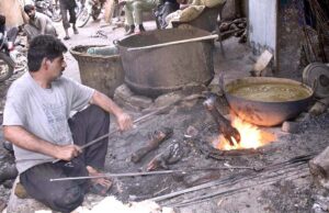 Workers cleaning hooves (Payas) of slaughtered animals with the help of burner at their workplace as per demand of local hotels.