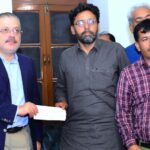 Sindh Senior Minister Sharjeel Inam Memon handing over a relief cheque of Rs10 million to the brother of martyred journalist Nasrullah Gadani at Karachi Press Club (KPC)
