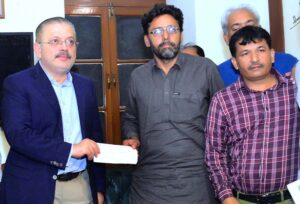 Sindh Senior Minister Sharjeel Inam Memon handing over a relief cheque of Rs10 million to the brother of martyred journalist Nasrullah Gadani at Karachi Press Club (KPC)
