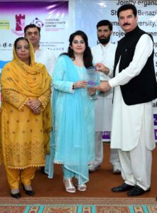 Governor KP Faisal Karim Kundi giving shield to Deputy Registrar SBBWUP Ms. Tashfeen Zia during a conference on Enhancing Regional Connectivity for the Betterment of the Shared Future of Mankind at SBBWU