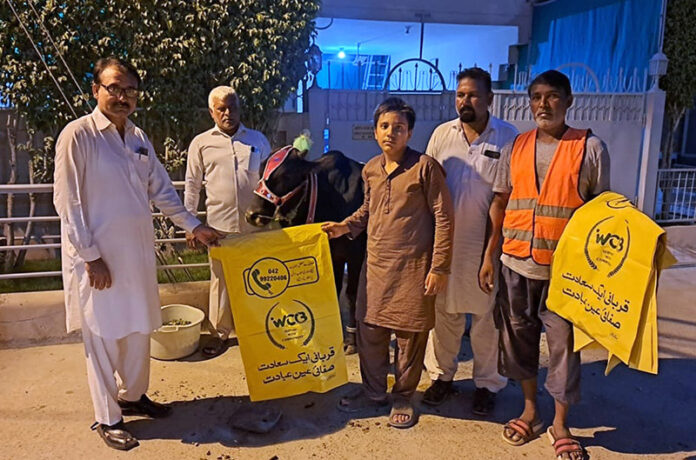 Cantonment Board staff handing over litter bags to the people who are sacrificing animals to dispose wastes of the animals on Eid-ul-Adha