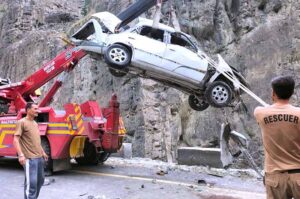 Rescue 1122 staffer busy in lifting car from the ditch after road accident at Nalter Express way.