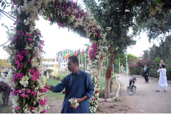 A person busy in decorating the entrance for preparation of Eidul Azha prayer at Polo Ground