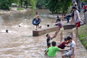 Youngsters diving in the canal to beat the scorching hot weather in the city.