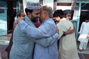 Faithful exchanging Eid greetings with each other after Eidul Azha prayers at Jamia Masjid Zia ul Aloom Satellite Town E-Block