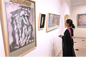 Visitor keenly observes the on displayed artworks during an Art exhibition at Gallery 6.