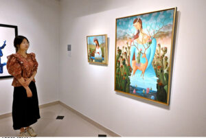 Visitor keenly observes the on displayed artworks during an Art exhibition at Gallery 6.