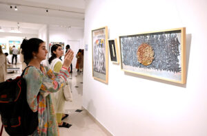 Visitor keenly observes the on displayed artworks during an Art exhibition at Gallery 6.