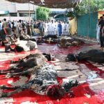 Butchers busy in slaughtering sacrificial animals at Jamia Masjid Zia ul Aloom Satellite Town on the first day of Eidul Azha