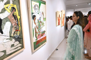 Visitor keenly observes the on displayed artworks during an Art exhibition at Gallery 6.