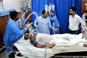 Medical staff giving treatment to the person at civil hospital who sustains burn injuries after cylinder explosion at Bhit Shah.