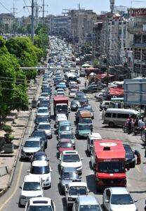 A massive traffic jam ensnares people in long waits, under the blazing sun, enduring the sweltering weather during peak hours in twin cities.