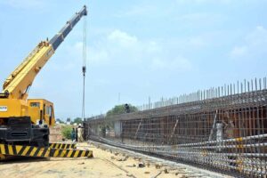 Labourers busy in construction work of flyover at under construction 10th Avenue during development work in Federal Capital