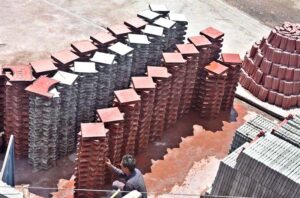 A labourer arranging tuff tiles after preparing in a local factory in the Federal Capital.