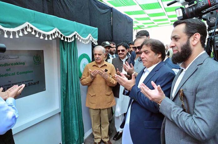Prime Minister Muhammad Shehbaz Sharif offering dua after unveiling a plaque during the groundbreaking of Jinnah Medical Complex