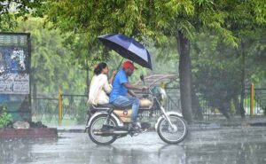 People standing under the bus stop shed at Expressway to take shelter during rain that experienced the Federal Capital.