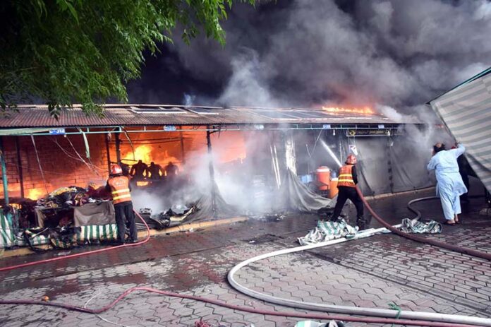 A view of smoke emitting after horrific fire erupts in weekly bazaar in H-9 sector. According to CDA as many as 300 stalls burnt to ashes in the incident. Luckily no causalities reported in the incident