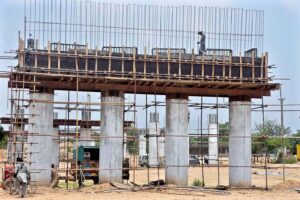 Labourers busy in construction work of flyover at under construction 10th Avenue during development work in Federal Capital