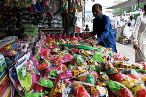 Vendor displaying Children's plastic toys to attract the customers at roadside in the city