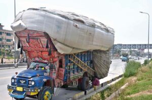 A view of truck heavily loading with chaff (husk from wheat) at IJP Road.