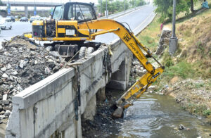 CDA staff busy cleaning the nullah with heavy machinery at Srinagar Highway in preparation for the monsoon season in the Federal Capital.