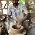 An artisan busy prepaying clay-made stuff at his work place in Kumharpara at Jamshoro road