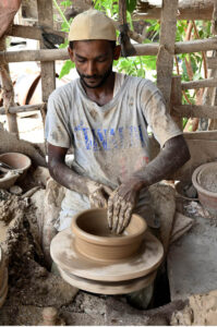 An artisan busy prepaying clay-made stuff at his work place in Kumharpara at Jamshoro road