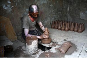 An artisan busy in preparing clay pots at his workplace in Pirwadhai area.