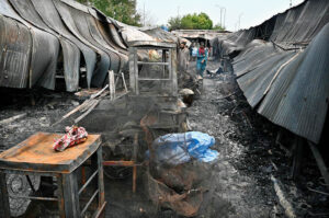 Stall holders examine and collecting the burnt remains of their stalls which burnt due to yesterday’s fire at the H-9 Weekly Bazaar