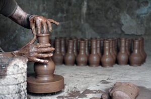An artisan busy in preparing clay pots at his workplace in Pirwadhai area.