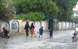 People on the way to their destination at Tarlai during rain that experienced in the Federal Capital.