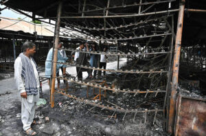 Stall holders examine and collecting the burnt remains of their stalls which burnt due to yesterday’s fire at the H-9 Weekly Bazaar