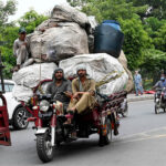 A person riding an overloaded tricycle rickshaw which may cause any mishap at Railway Station Road