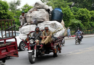 A person riding an overloaded tricycle rickshaw which may cause any mishap at Railway Station Road
