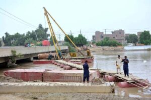 Labourers busy in construction work of bridge on the Pinyari Canal.