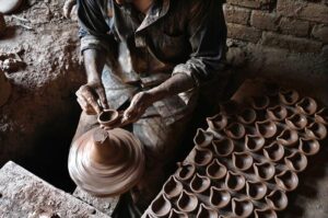 An artisan busy in preparing clay pots at his workplace in Pirwadhai area.
