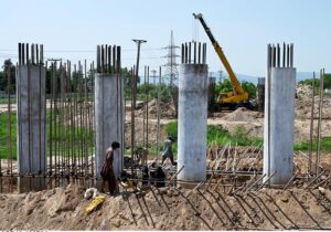 Labourers busy in construction work of flyover at under construction 10th Avenue during development work in Federal Capital