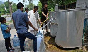 People filling their pots with clean drinking water from filtration plant at F-6 in the Federal Capital