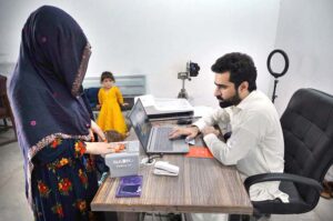 A female Afghan refugee provides fingerprints for updating her Proof of Registration (POR) card at the PCM center in Chamkani, following the government's extension until June 30, 2025.